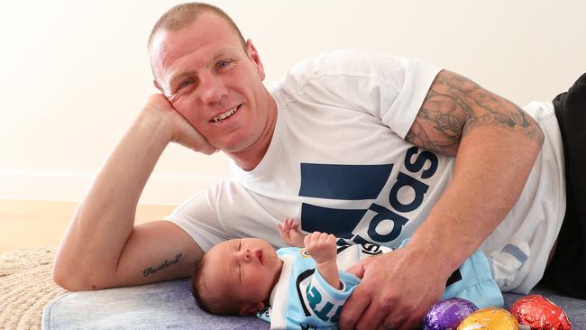 Lewis with his son Levi at his home in Cronulla. Picture: Brett Costello