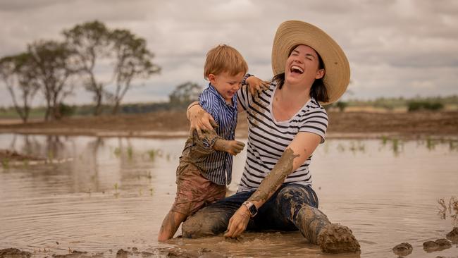 Shannon Crocker with son Angus (3) playing in the mud at their Muckadilla property after a week of rain. Photo - Katarina Silvester