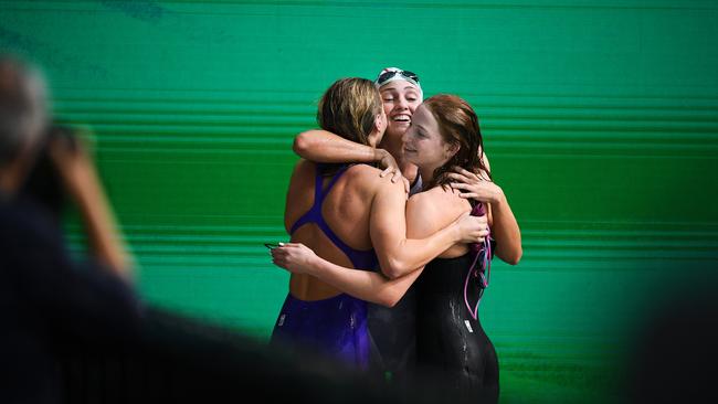 Ariarne Titmus, Meg Harris and Mollie O'Callaghan hug after all qualifying Australian National Olympic Swimming Trials. (Photo by Mark Brake/Getty Images)