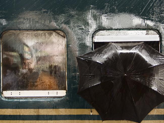 The Man’s Stare The photo was taken on 23rd of July 2016 at Tongi Railway Station, Gazipur, Bangladesh. I was there for taking photos and waiting for a moment. A train from Dhaka toward another district has reached and stopped at the platform for 5 min for lifting passengers. It was huge raining. Suddenly I found a pair of curious eye was looking at me through the window and on his left an umbrella has been put for protect the rain. I got the moment. Picture: Moin Ahmed / National Geographic Travel Photographer of the Year