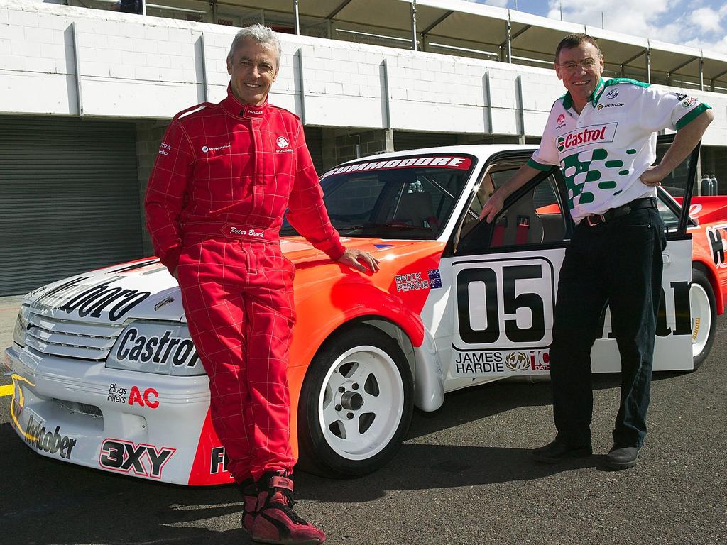 Racing drivers Peter Brock and Larry Perkins with the Holden Dealer Team 1984 Marlboro 05 VK Commodore race car, at Sandown in Melbourne in September 2003. Picture: Supplied