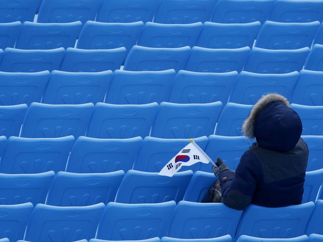 A spectator holds a South Korean flag as she watches the slalom portion of the men’s combined at the 2018 Winter Olympics in Jeongseon, South Korea, Tuesday, Feb. 13, 2018. Picture: AP