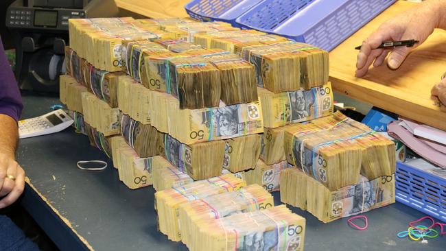 Mounds of cash have been seized by AFP officers investigating organised crime.