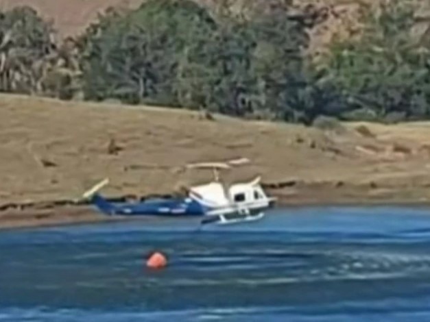 The helicopter above the dam at Tarome, moments before the crash. (Photo: 7News)