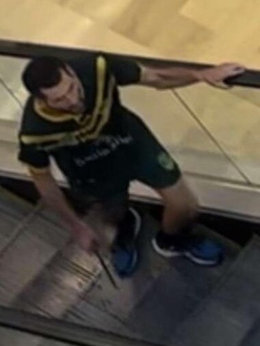 The stabber climbs an escalator as he prowls the shopping centre.