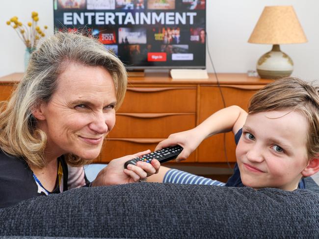 MELBOURNE, AUSTRALIA -  DECEMBER 7 2023 Claire Rosel and son Clancy 10, fight over a tv remote.New data on Aussie TV viewing habits reveals just how much time we waste scrolling and caught in indecision - which is why we need a service like Hubbl.Picture: Brendan Beckett