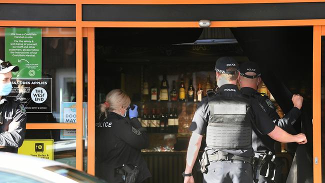 Police at the scene of a robbery after two armed men stole cash from The West End hotel and bottle shop on Hindley St. Picture: Mark Brake