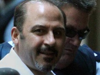 24/11/2011 NEWS: Supreme Court. Tony Mokbel looks up with a grin as he arrives alone in a prison van (with support van with armed guards one with a shotgun, standing by as he was unloaded)