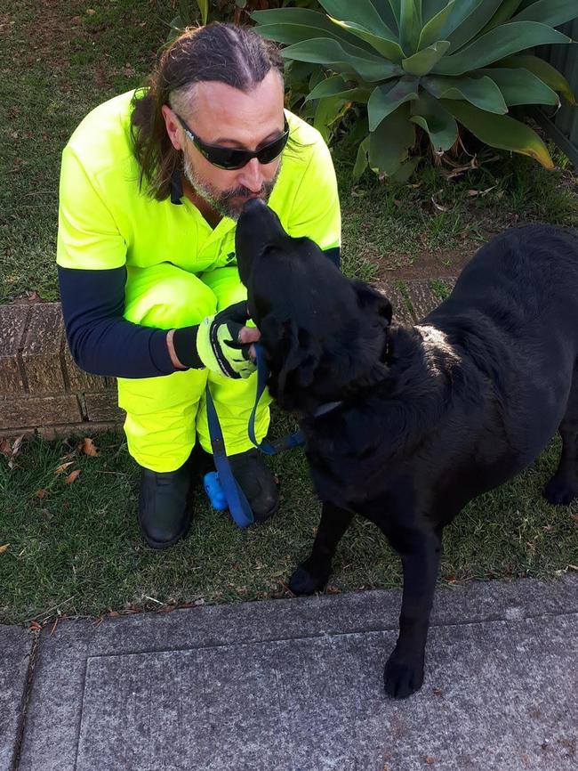 Postman Richard Pumpa catches up with one of the dogs caught in the fire.