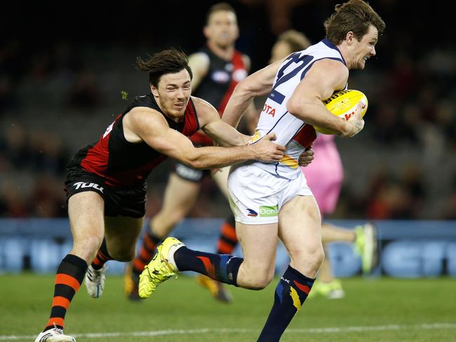 Michael Hibberd attempts to tackle Patrick Dangerfield at Etihad Stadium.