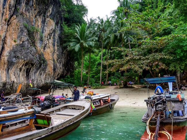 This photograph taken on November 25, 2020 shows longtail boats moored on the beach of one of the Koh Hong islands in the Andaman Sea. (Photo by Mladen ANTONOV / AFP)