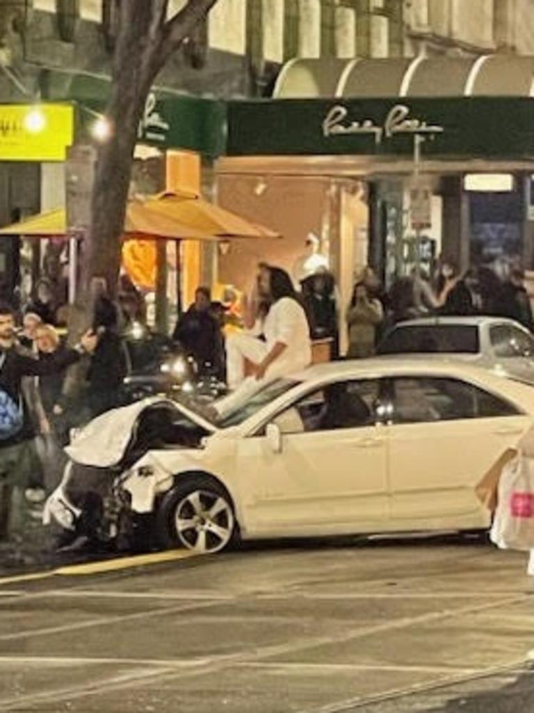 Police arrested a man sitting on top of a vehicle after it collided with other cars and pedestrians in Bourke St on Friday evening. Picture: Supplied.