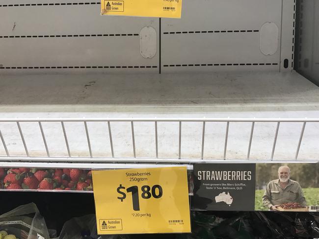 Empty shelves, normally stocked with strawberry punnets, are seen at a Coles Supermarket in Brisbane. Picture: Dan Peled