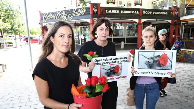 Cairns Regional Domestic Violence Service court support officer Leah (withheld) with Tegan Hicks and Ashleigh Lawrence from the NQ Women’s Legal Service at the Red Rose Rally for DV in the Cairns CBD. Picture: Peter Carruthers