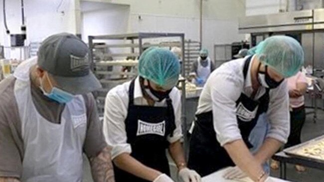 Harry and Meghan with former gang members at an LA bakery. Picture: Instagram.