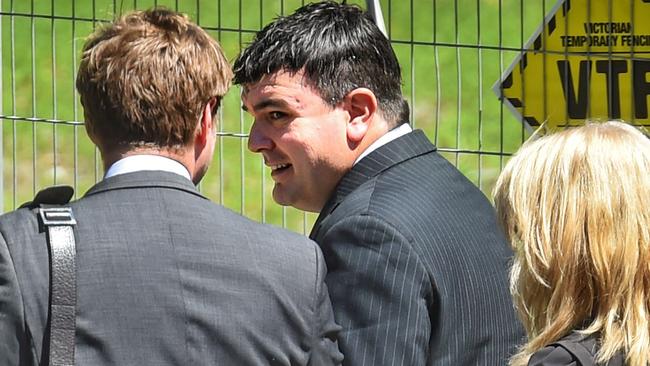 Police officer Daniel Sciore (centre) leaving Ringwood Magistrates Court. Picture: Tony Gough.