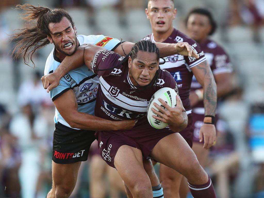 Toby Rudolf comes to grips with Manly's powerhouse Martin Taupau during the NRL trial match between Manly and Cronulla at Jubilee Oval, Kogarah. Picture: Brett Costello