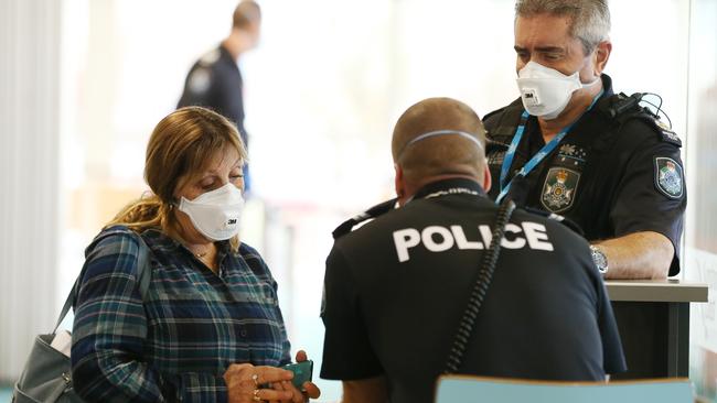 A passenger who flew into Sunshine Coast Airport from Melbourne goes through questioning with Queensland Police on arrival. Picture: Lachie Millard