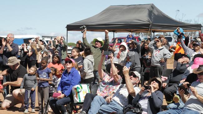 The crowd cheer and celebrate the successful launch the rockets at the Koonibba test range. Picture: Andrew Brooks