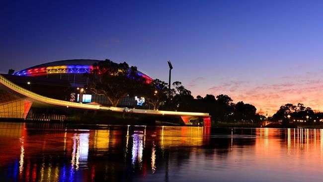 Adelaide Oval and the footbridge lit up in Crows colours after Walsh’s passing. Picture: Jase Woody (Facebook).