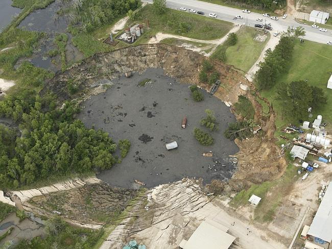 Sudden...A massive sinkhole near Daisetta, Texas, which swallowed oil field equipment and vehicles after suddenly appearing in 2008 and then continuing to grow.. Picture: AP