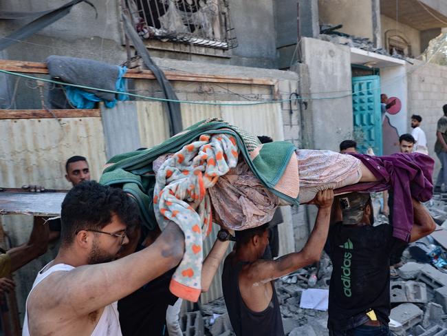 Palestinians carry away the body of a person killed in an Israeli strike in Nuseirat in the central Gaza Strip. Picture: AFP