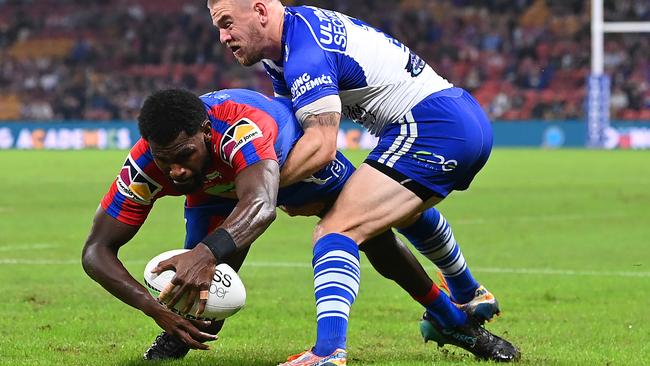 Edrick Lee slips past Matt Dufty to score for the Knights. Picture: Bradley Kanaris/Getty Images