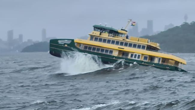 An Emerald Class 2 ferry, used on the Manly to Circular Quay route, battles huge swells near Sydney Heads during heavy sea trials on Sydney Harbour. Picture: Mark Crawley