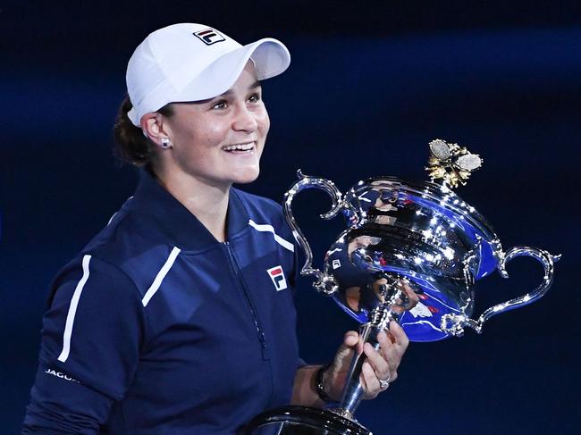 Australia's Ashleigh Barty holds the trophy after winning against Danielle Collins of the US during their women's singles final match on day thirteen of the Australian Open tennis tournament in Melbourne on January 29, 2022. (Photo by William WEST / AFP) / -- IMAGE RESTRICTED TO EDITORIAL USE - STRICTLY NO COMMERCIAL USE --