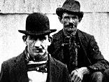 1900. Rat catchers hired to help fight bubonic plague that hit Sydney stand beside pile of their latest catch.