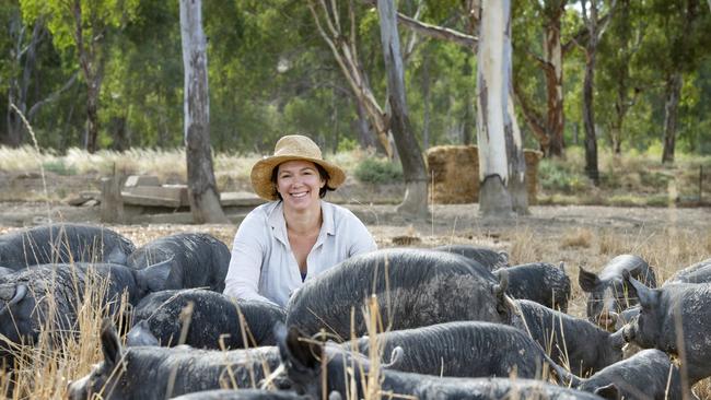 Lauren Mathers with her Berkshire pigs at Barham, where Murray Plains Meat Cooperative has built a micro-abattoir to process cattle, lambs, pigs, poultry, buffalo and goats.