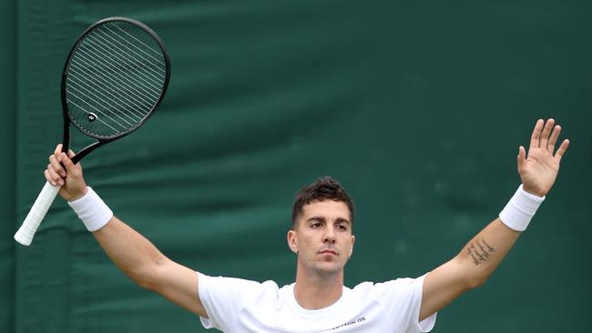 LONDON, ENGLAND - JULY 03: Thanasi Kokkinakis of Australia celebrates winning match point against Felix Auger-Aliassime of Canada in his Gentlemen's Singles first round match during day three of The Championships Wimbledon 2024 at All England Lawn Tennis and Croquet Club on July 03, 2024 in London, England. (Photo by Clive Brunskill/Getty Images)