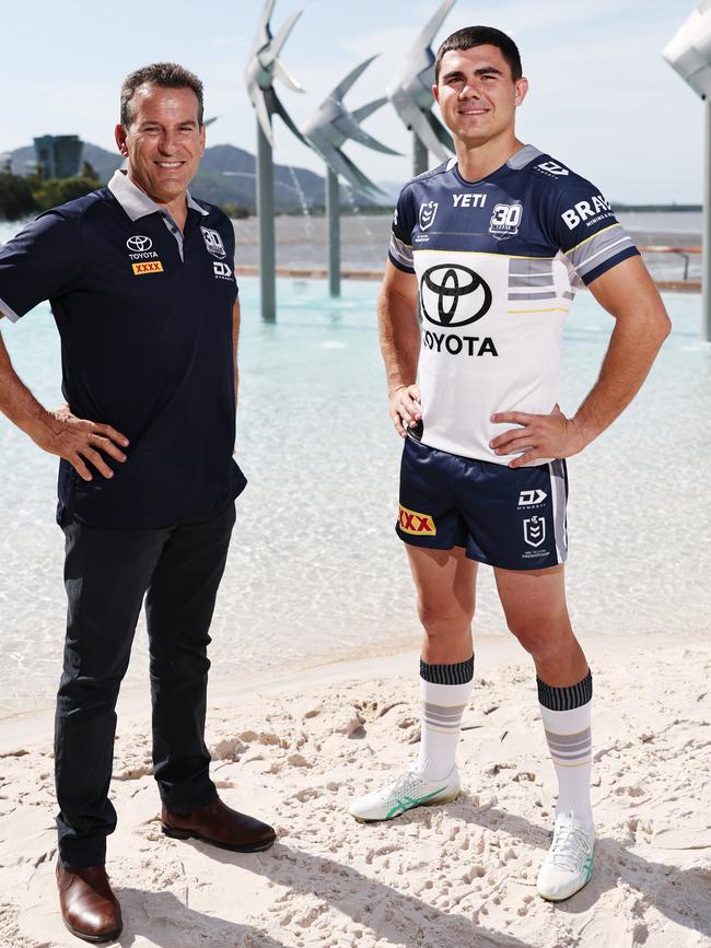 The North Queensland Cowboys have visited Cairns to launch their 30th anniversary jersey, which will be worn for the 2025 NRL season. North Queensland Cowboys 1995 season player Dean Schifilliti helps launch the club's 30 year jersey at the Cairns Esplanade lagoon with current player Jake Clifford. Picture: Brendan Radke