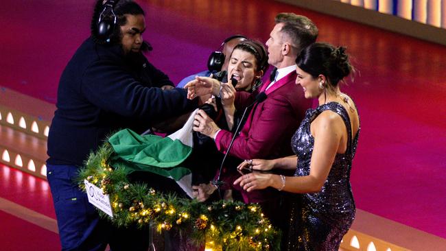 Pro-Palestine protesters are taken away by security after interrupting the Carols by Candlelight concert at the Sidney Myer Music Bowl in Melbourne. Picture: AAP