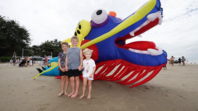 Liam Miller, 6, Blake Miller, 7, and Peyton Miller, 3, marvel at the size of the kites on Four Mile Beach when the attended Port Douglas Carnivale's family beach day on Saturday. Picture: Brendan Radke