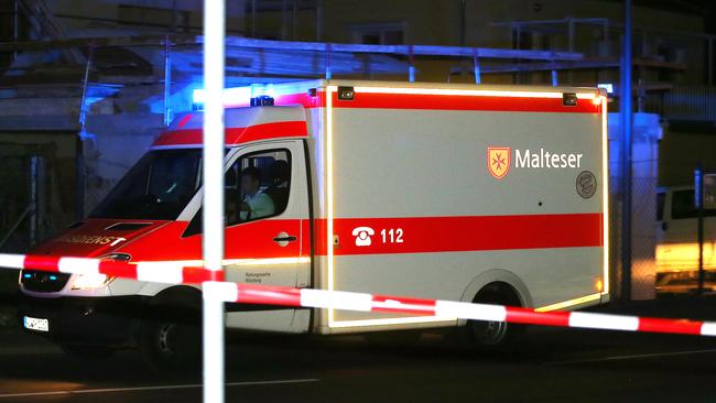 An ambulance stands at a roadblock in Wuerzburg, southern Germany, where a man attacked people in a train and injured several of them. Picture: Karl-Josef Hildenbrand/DPA/AP