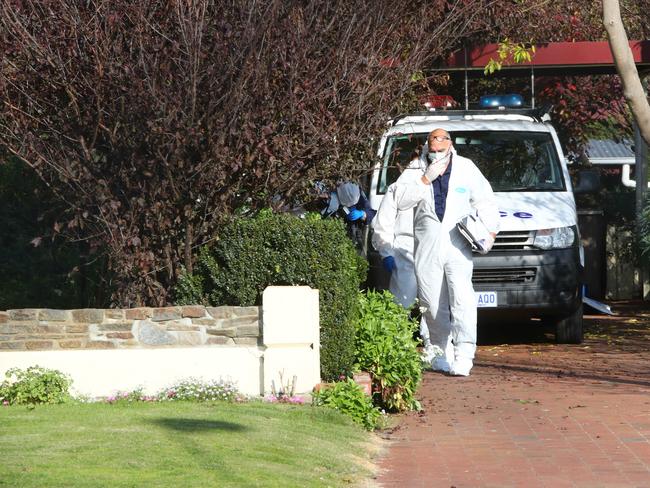 Crime scene officers at the front of a house on Plunkett Tce, Millicent, where the bodies of two women were found.