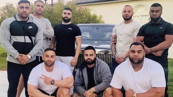 Zakaria (front right) poses for a photo with friends in front of a Rolls Royce. Picture: Supplied