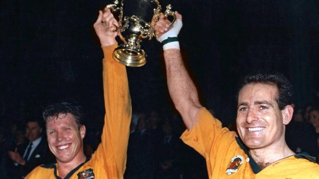 Australian captain Nick Farr-Jones (left) and teammate David Campese raise the Webb Ellis Cup after the Wallabies’ victory over England in the 1991 Rugby World Cup final. Picture: AFP