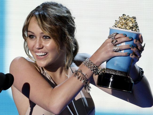 Miley Cyrus accepts the award for best song from a movie for 