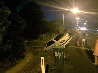 No one was injured when a car took a wrong turn off Ballina Rd at Lismore Heights on Wednesday and ended up perched precariously on an almost vertical slope. Photo: Rodney Stevens. Picture: Photo: Rodney Stevens