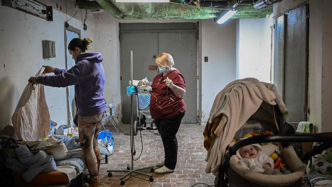 A nurse checks a baby being treated at a paediatrics centre after unit was moved to the basement of the hospital which is being used as a bomb shelter, in Kyiv. Picture: Aris Messinis / AFP