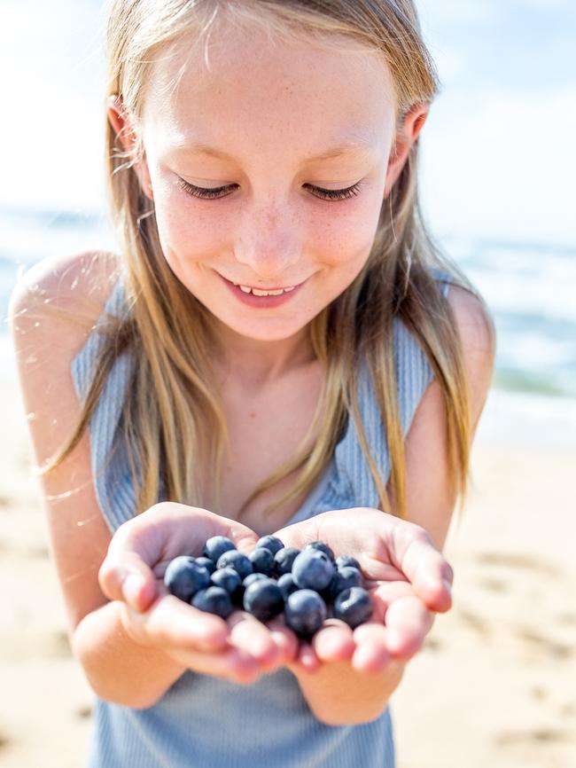 April Savage holding fresh blueberries. Picture: Supplied