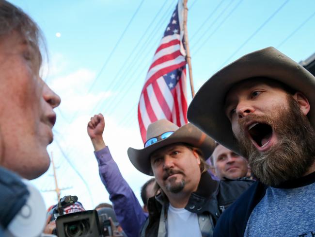 Clash of cultures ... A protester confronts supporters of Republican presidential candidate Donald Trump in downtown Salt Lake City. Picture: AP