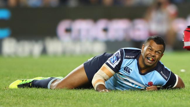 Kurtley Beale of the Waratahs looks to the sideline after injuring his knee.