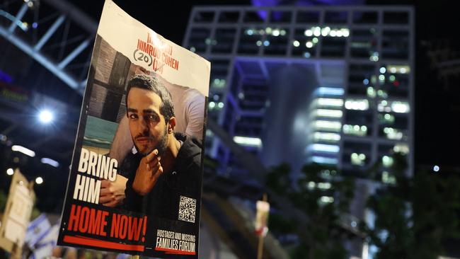 An protester carries a portrait of Nimrod Cohen, an Israeli hostage held by Palestinian militant group Hamas in Gaza, during an anti-government demonstration in the Israeli coastal city of Tel Aviv, on October 19. Picture: Jack Guez/AFP