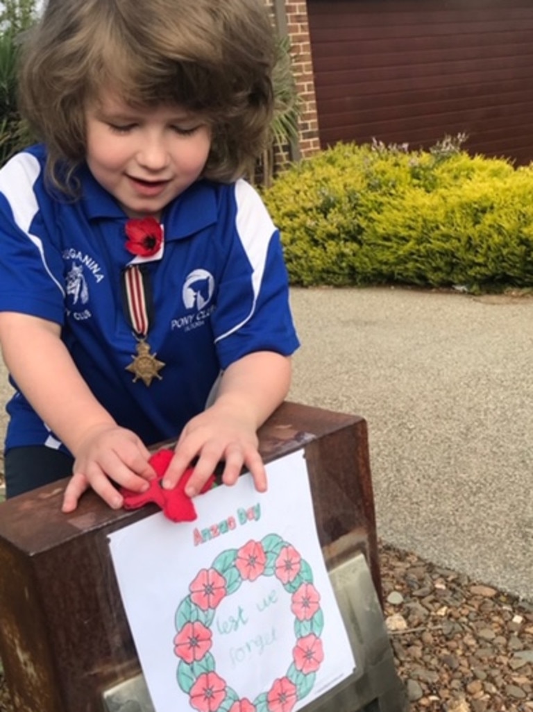 Angus, 6, puts out a tribute on Anzac Day.