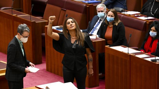 Australia Greens Senator for Victoria Lidia Thorpe raises her arm during her swearing-in ceremony in the Senate chamber.