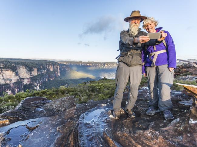 A couple taking a selfie while bushwalking in the Blue Mountains.