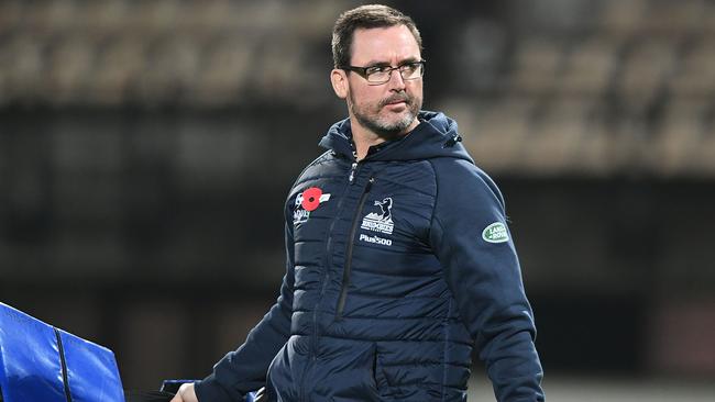 Brumbies coach Dan McKellar holds tackle bags before a Super Rugby match.